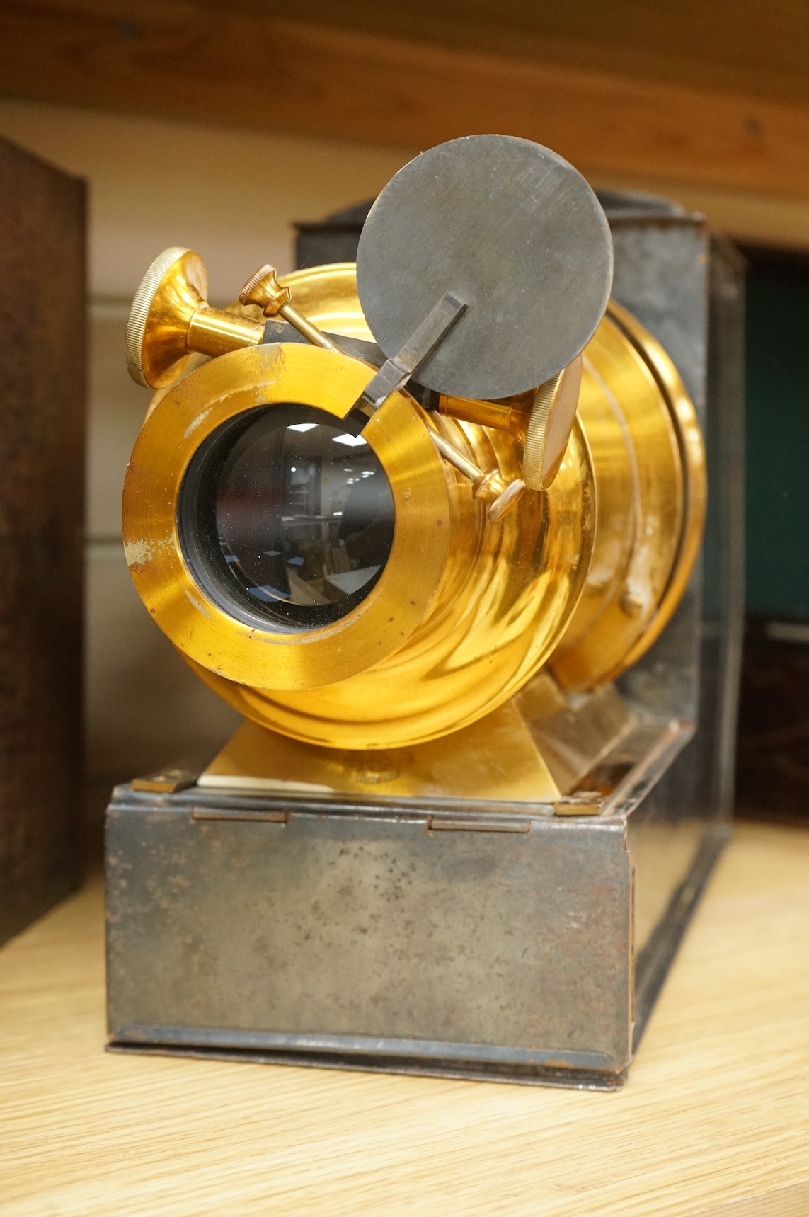 A tinplate and brass magic lantern, converted to an electric lamp and missing the original chimney, in a tin case, together with a case of slides, mostly biblical related.